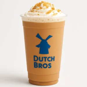 Dutch Bros Cookie Butter Latte in a clear cup with cookie crumble topping on a white background