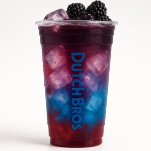 Tall clear Dutch Bros cup of layered Dragon Slayer iced drink with raspberry, blue raspberry, blackberry float, fruit garnish, and white background.

