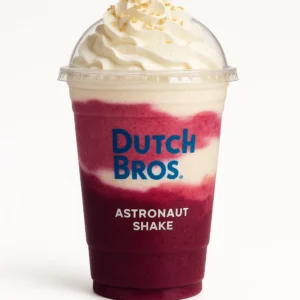 Dutch Bros Astronaut Shake with blackberry, raspberry, and almond flavors, topped with whipped cream, on a white background.