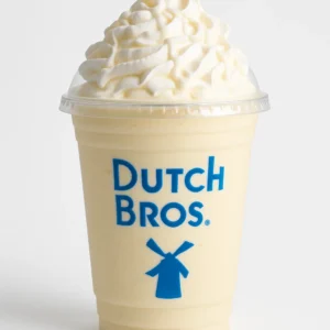 Dutch Bros Banana Cream Pie Shake with banana and white chocolate flavors, topped with whipped cream, on a white background.