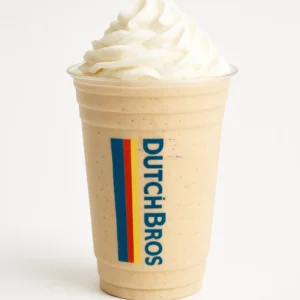 Dutch Bros Cookie blended drink with whipped cream in a clear branded cup, on white background.

