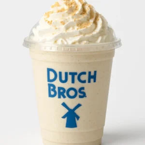 Dutch Bros Cookie Shake with white chocolate, macadamia nut flavor, whipped cream, and cookie crumbs on a white background.