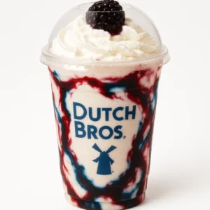 Dutch Bros Dragon Slayer Shake with raspberry, blue raspberry, and blackberry float, topped with whipped cream on a white background.