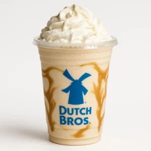 Dutch Bros Dream Weaver Shake with hazelnut and white chocolate, topped with whipped cream on a white background.