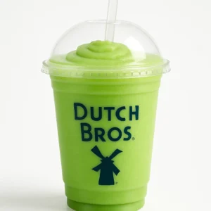 Dutch Bros Green Apple Smoothie in a clear plastic cup with dome lid and straw on a white background.