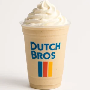 Dutch Bros Kicker blended Irish cream coffee in a clear branded cup with whipped cream, on white background.

