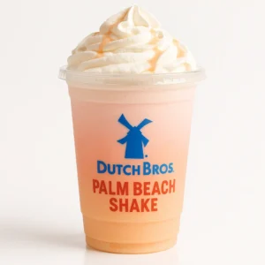 Dutch Bros Palm Beach Shake with pomegranate and peach on a white background.