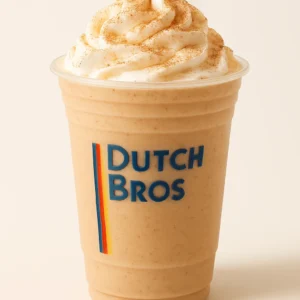 Dutch Bros Snickerdoodle blended drink with whipped cream and cinnamon sprinkles in a clear branded cup, on white background.

