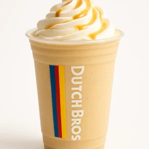 Dutch Bros Toasted Mellow blended drink with whipped cream and light drizzle in a clear branded cup, on white background.


