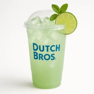 Tall clear Dutch Bros cup of pale green Dutch Mojito iced drink with lime, mint garnish, and white background.

