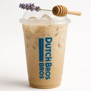 Tall clear Dutch Bros cup of creamy iced Earl Grey tea with oat milk, lavender garnish, and white background.

