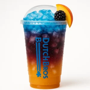 Tall clear Dutch Bros cup of layered Eclipse iced drink with peach, passion fruit, blackberry, blue raspberry float, fruit garnish, and white background.

