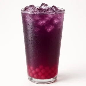 Poppin’ Boba Berry Lemonade with blackberry lemonade and strawberry boba pearls in a clear cup on a white background.


