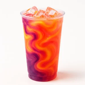 Colorful Ray of Sunshine Rebel drink with blackberry, peach, and grapefruit syrups served over ice.
