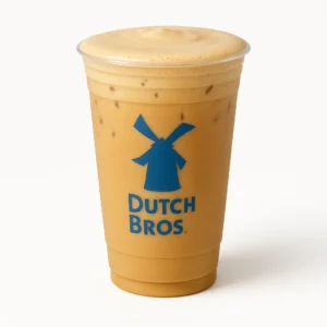 Dutch Bros Salted Caramel Protein Latte with creamy foam in a tall clear cup on a white background
