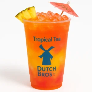 Dutch Bros Tropical Tea in a modern clear cup with ice, tropical colors, pineapple garnish, and a mini umbrella.

