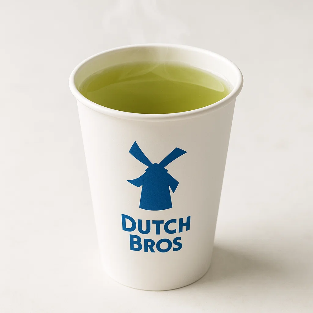 "Dutch Bros branded paper cup with Green Hot Tea, showing a pale green color and steam rising in a minimalistic café environment."